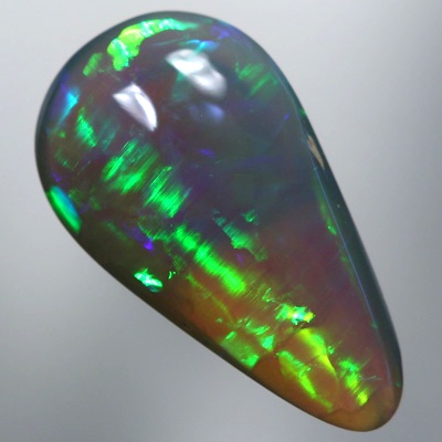 SOLID SEMI BLACK OPAL Chasing rolling flashes through greens and turquoise